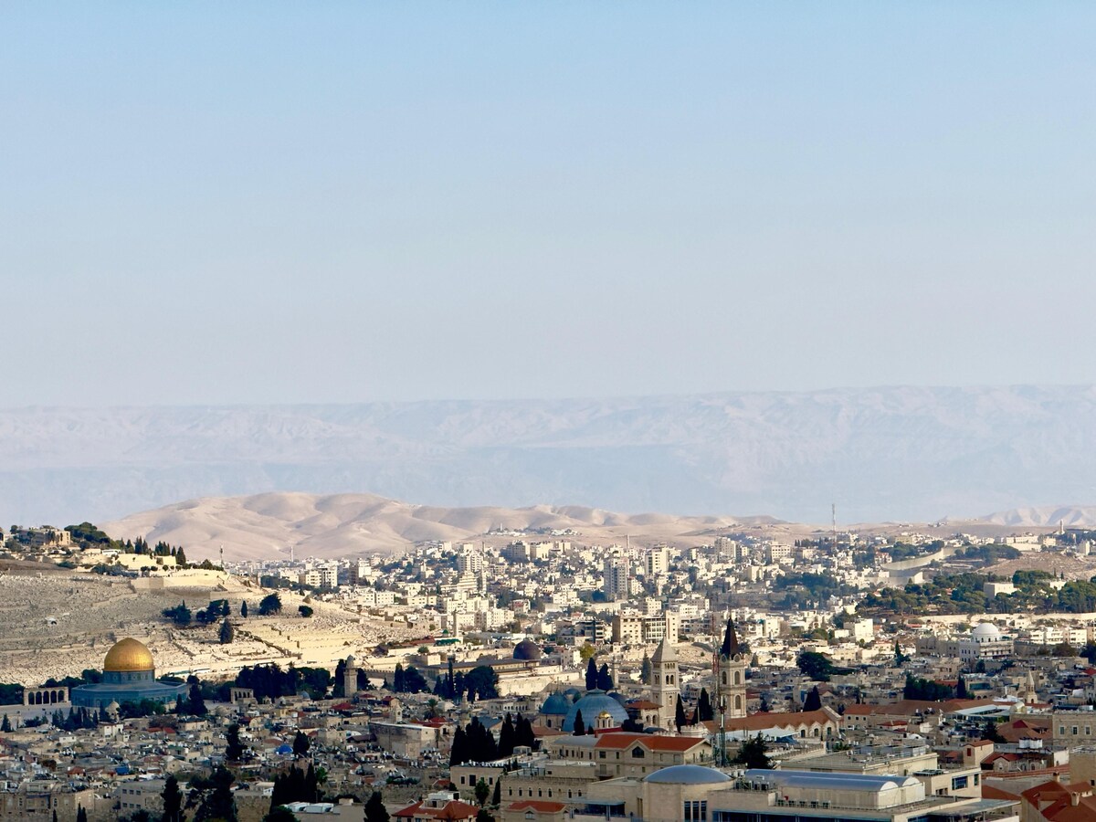 A wider view from the penthouse over the Temple Mount, Jerusalem rooftops, and distant hills