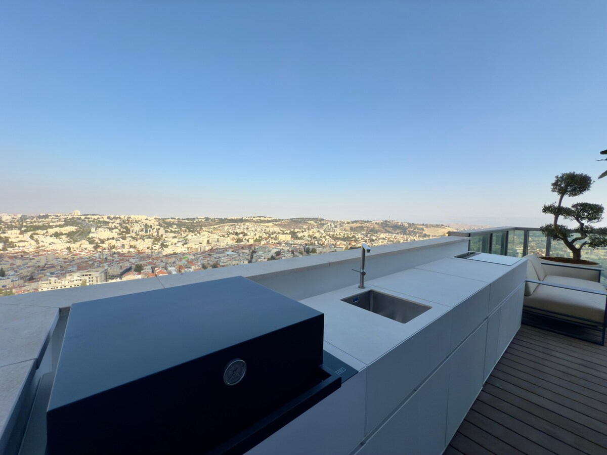 Outdoor grill and kitchen with a city view